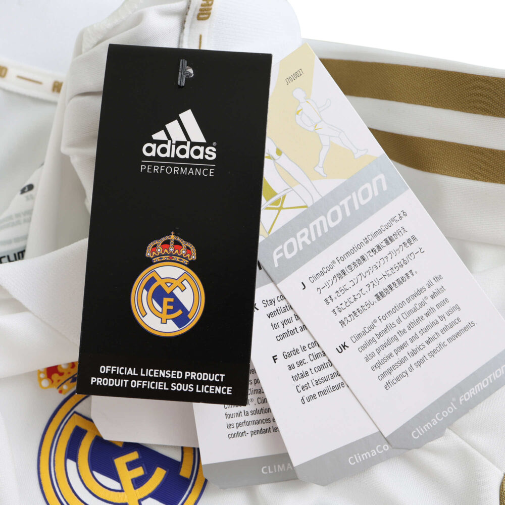 Close-up of the Real Madrid Retro Home 2011/12 Player Version jersey, featuring tags and club crest.