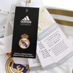 Close-up of the Real Madrid Retro Home 2011/12 Player Version jersey, featuring tags and club crest.