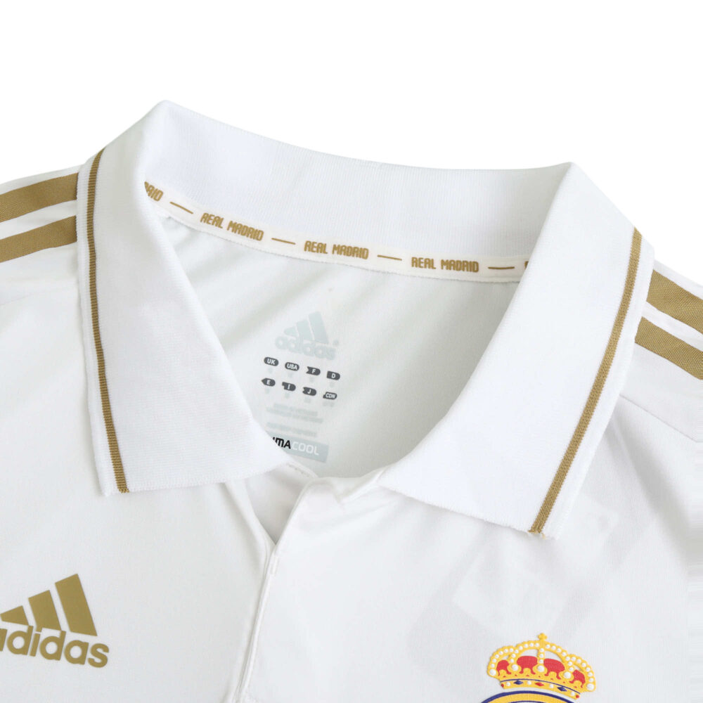 Image of the collar and chest area of a Real Madrid Retro Home 2011/12 Player Version jersey, highlighting logos and details.