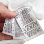 Close-up of care and manufacturing labels inside the Real Madrid Retro Home 2011/12 Player Version jersey.