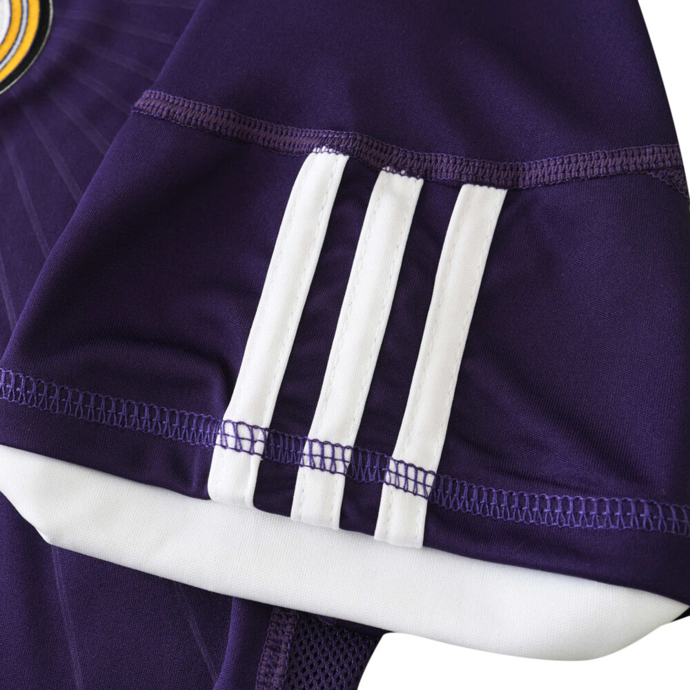 Close-up of Real Madrid Retro Third 2010/11 Fan Version shirt sleeve in purple with white stripes.