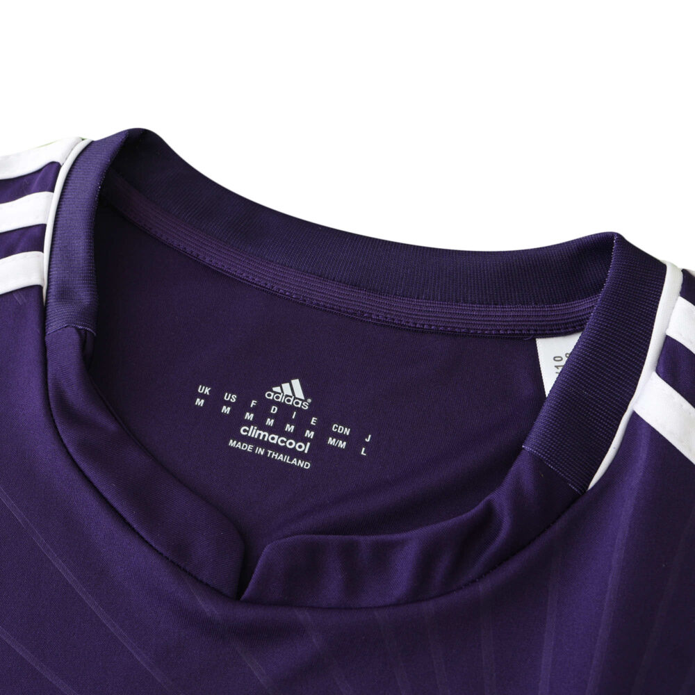 Close-up of a purple Real Madrid Retro Third Jersey 2010/11 Fan Version, highlighting the collar and Adidas branding.