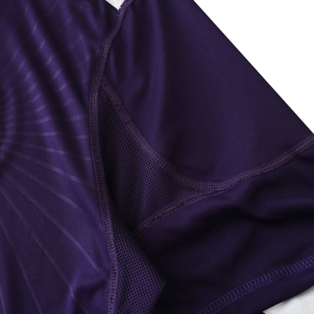 Close-up of Real Madrid Retro Third Fan Version jersey from the 2010/11 season, showcasing purple fabric and stitching details.