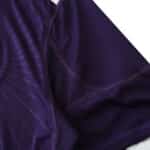Close-up of Real Madrid Retro Third Fan Version jersey from the 2010/11 season, showcasing purple fabric and stitching details.