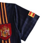 Close-up of the Spain Retro Away 1996 Fan Version jersey showing the Spain coat of arms and striped sleeve detail.