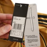 Close-up of tags on Spain Retro Away 2008 Fan Version jersey, displaying adidas branding and product details.