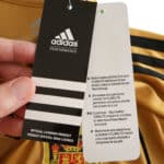 Close-up of Spain Retro Away | 2008 | Fan Version tags, showing Adidas Performance branding and product details.