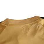 Close-up of the back collar area of Spain Retro Away | 2008 | Fan Version in gold fabric displayed on a product page.