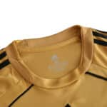 Close-up of the neck area of a gold Spain Retro Away 2008 Fan Version jersey with Adidas logo and size label printed inside.