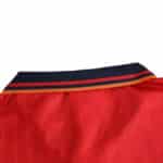 Close-up view of the collar on the Spain Retro Home 1994 Fan Version jersey, featuring navy and red stripes.