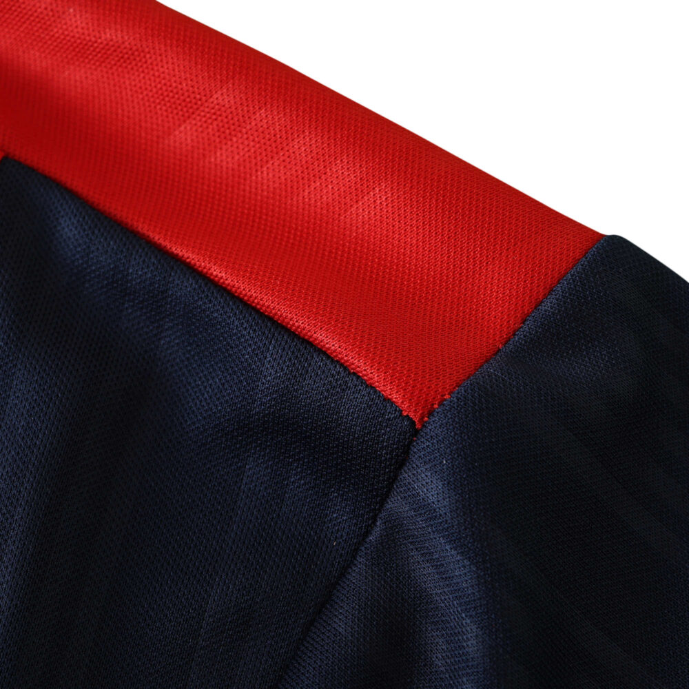 Close-up of Spain Retro Home 1996 Fan Version jersey's collar, featuring a red trim on a dark blue fabric.