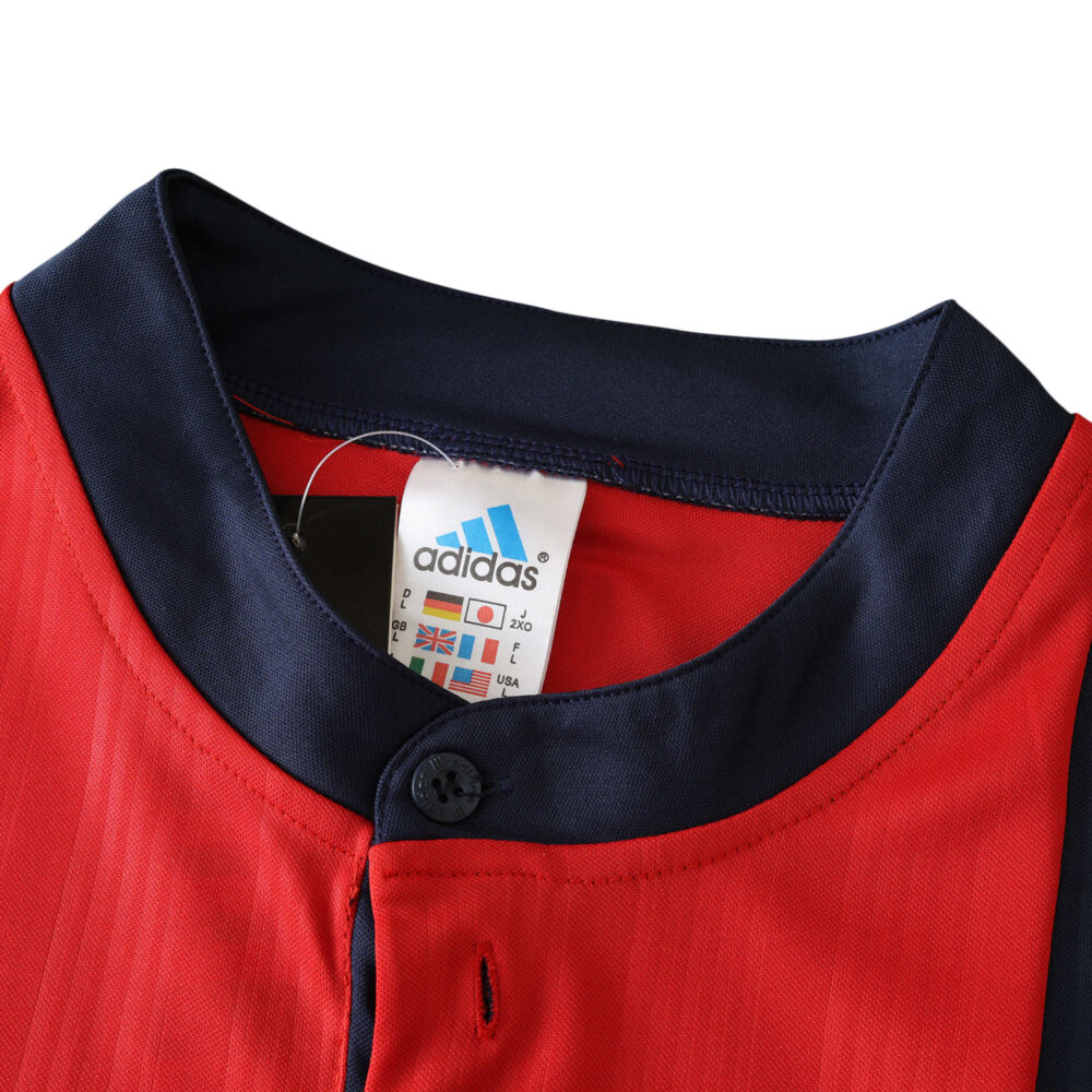 Close-up of Spain Retro Home 1996 Fan Version jersey collar with adidas label and button detail.