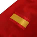 Close-up of the sleeve design on Spain Retro Home 2002 Fan Version jersey, showcasing a patch with the Spanish flag colors.