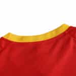 Close-up of the collar detail on the Spain Retro Home 2002 Fan Version jersey, showing yellow and red fabric.