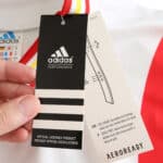 Close-up of the Spain Retro Third 1996 Fan Version tag showing Adidas and Aeroready branding.