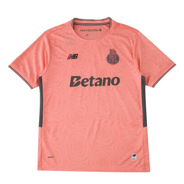 FC Porto 2025/26 away fan jersey in coral pink with sponsor, club crest, and New Balance logo.