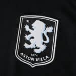 Close-up of Aston Villa 2025/26 Away Player Version jersey badge featuring the club's lion crest.