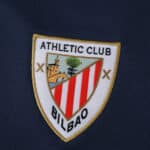 Athletic Bilbao 2025/26 away fan jersey badge with club crest on dark fabric background.