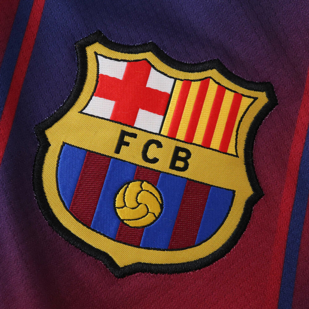 Close-up of the FC Barcelona crest on the 2025/26 home fan version jersey.