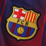 Close-up of the FC Barcelona crest on the 2025/26 home fan version jersey.