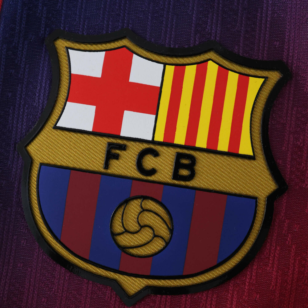 Close-up of the FC Barcelona crest on the 2025/26 home player version jersey.