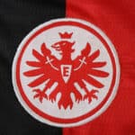 Eintracht Frankfurt 2025/26 home fan jersey crest with red eagle on black and red background.
