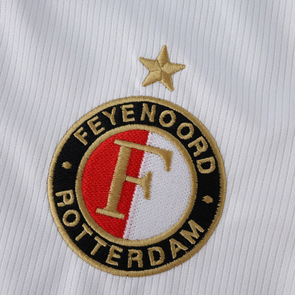 Feyenoord Rotterdam crest with gold star on the 2025/26 home fan version jersey white fabric.
