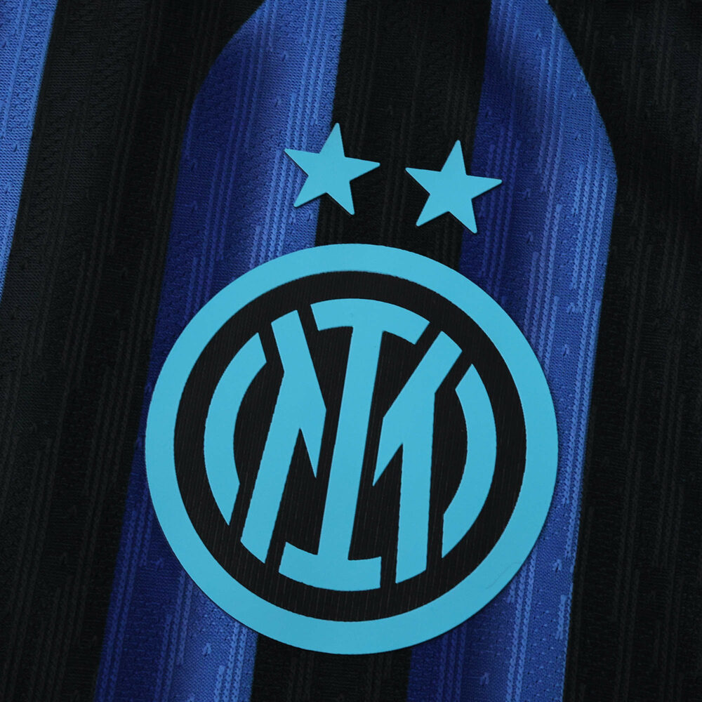 Close-up of Inter Milan 2025/26 Home Player Version jersey featuring club crest and blue-black stripes.