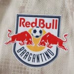 Close-up of New York Red Bulls Away 2025/26 Player Version jersey badge featuring two red bulls and a soccer ball.