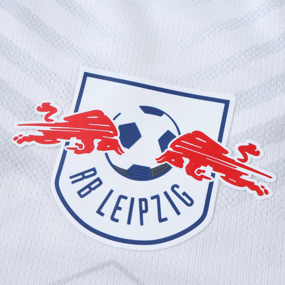 Close-up of the RB Leipzig crest on the 2025/26 home fan version jersey.