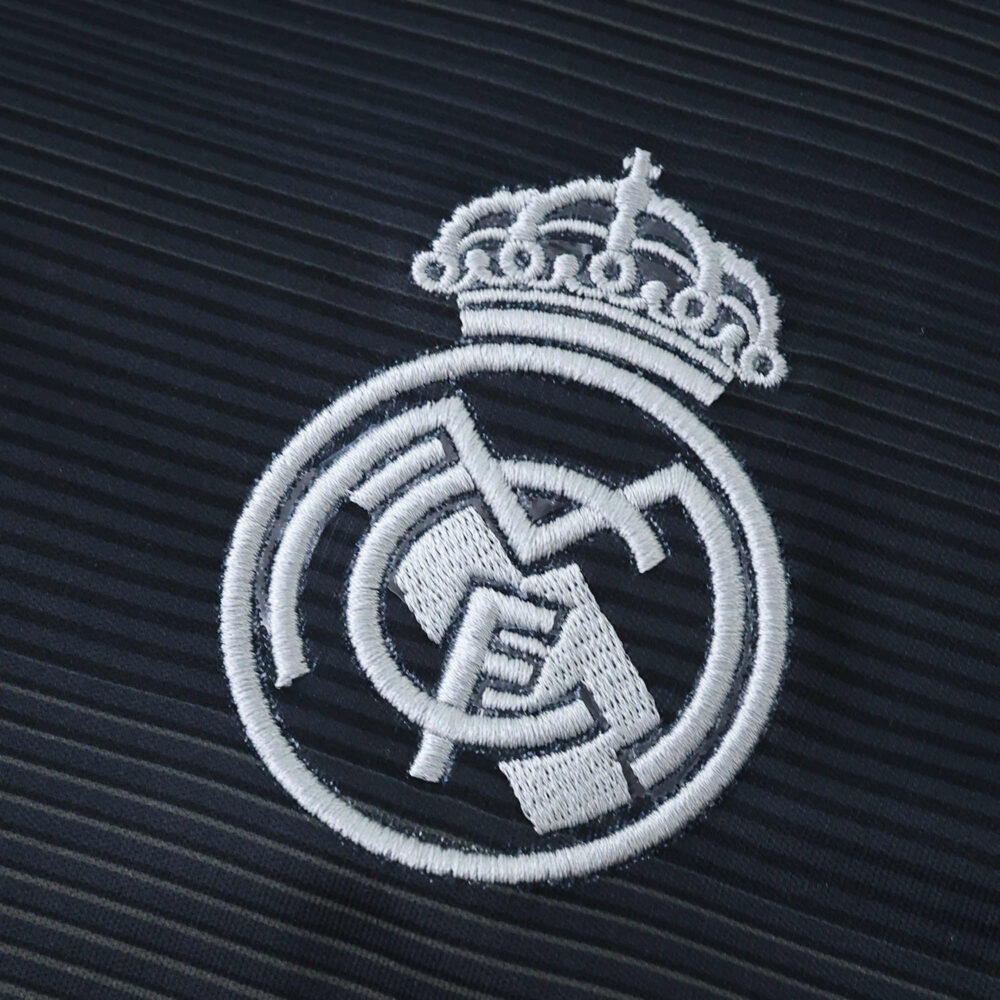Close-up of the embroidered Real Madrid crest on the 2025/26 away fan version jersey.
