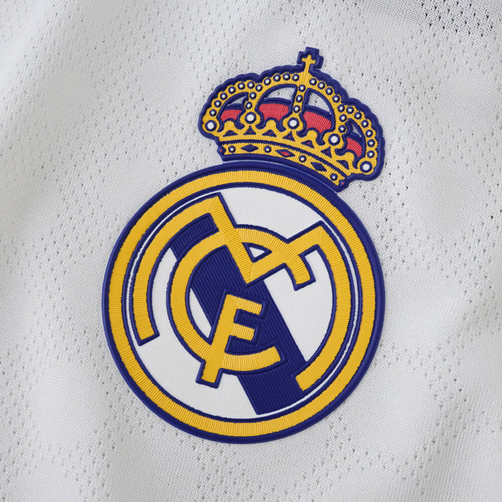 Close-up of the Real Madrid crest on the 2025/26 Home Player Version jersey fabric.