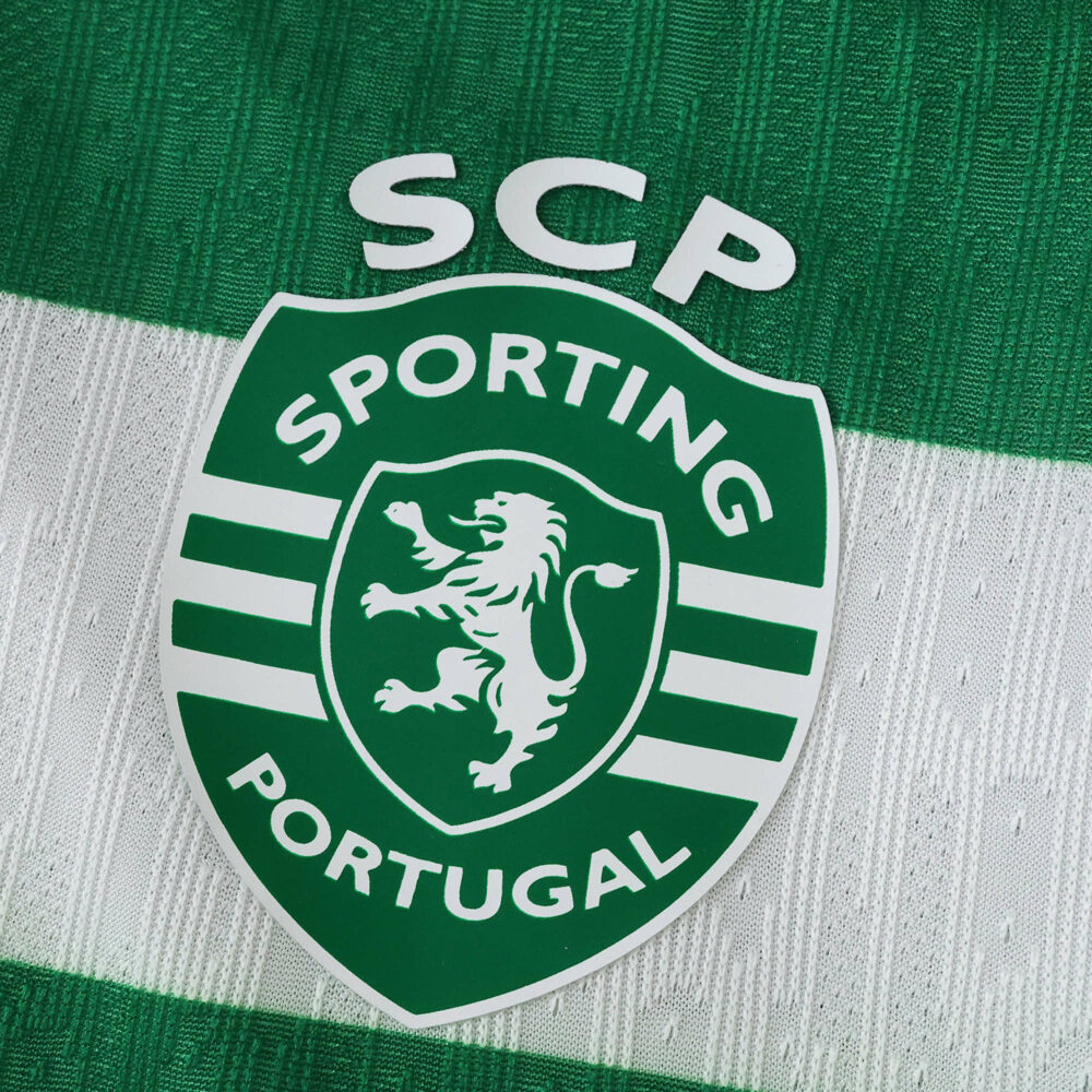 Close-up of the Sporting CP 2025/26 Home Player Version jersey featuring the club crest on green and white fabric.