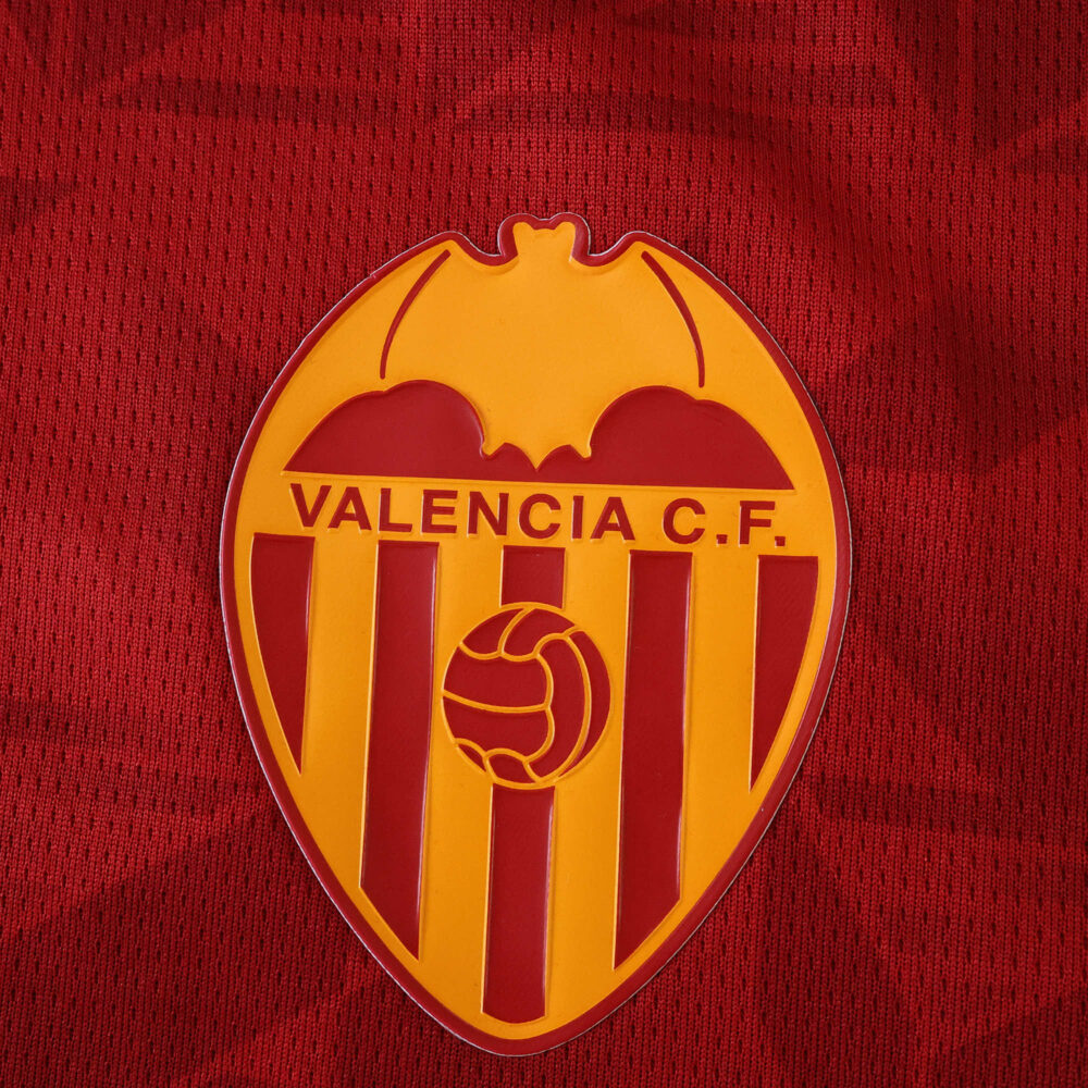 Valencia C.F. crest on the 2025/26 away fan jersey, featuring a red and gold design.