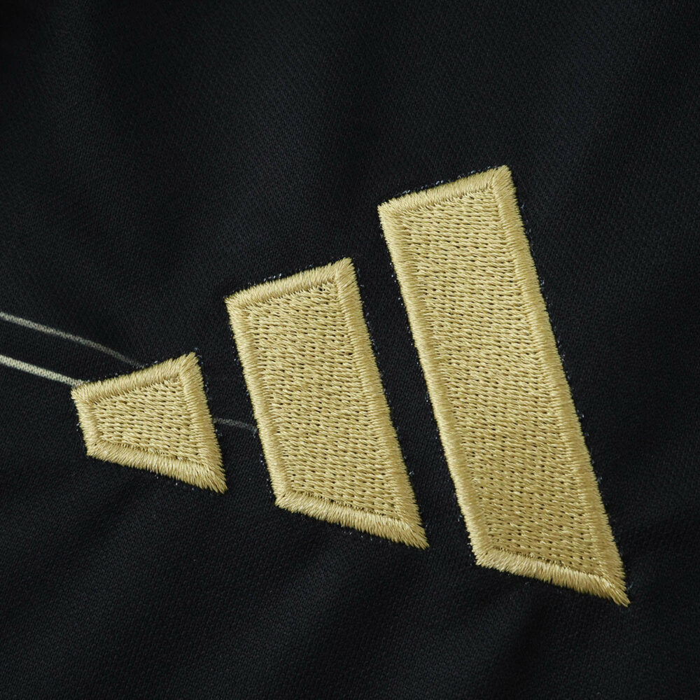 Close-up of the gold Adidas logo on the Aberdeen Away 2025/26 Fan Version jersey fabric.