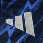 Close-up of the 2025/26 Arsenal Away Fan Version jersey featuring a geometric blue pattern and white logo.
