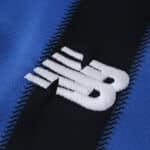 Close-up of the New Balance logo on the 2025/26 Atalanta Home Fan Version football jersey.