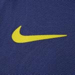 Yellow Nike logo on purple Atlético Madrid Away 2025/26 fan jersey fabric.