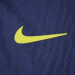 Close-up of the yellow Nike logo on the Atlético Madrid 2025/26 away player version jersey fabric.
