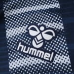 Close-up of the Hummel logo on the Celta Vigo Away 2025/26 Fan Version jersey with a dotted pattern.
