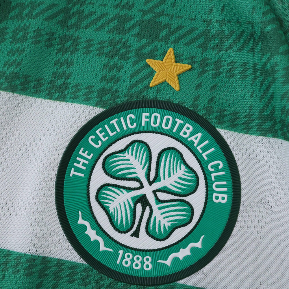 Close-up of the 2025/26 Celtic Home player version jersey badge and gold star on green hoops.