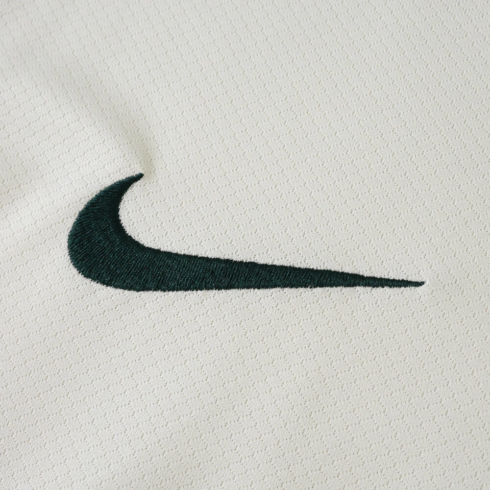 Close-up of black Nike logo on the Chelsea Away 2025/26 Fan Version jersey’s white fabric.