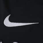 White Nike logo embroidered on black fabric of Corinthians Away 2025/26 Fan Version jersey.
