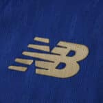 Gold New Balance logo on textured blue FC Porto 2025/26 Home Player Version jersey fabric.