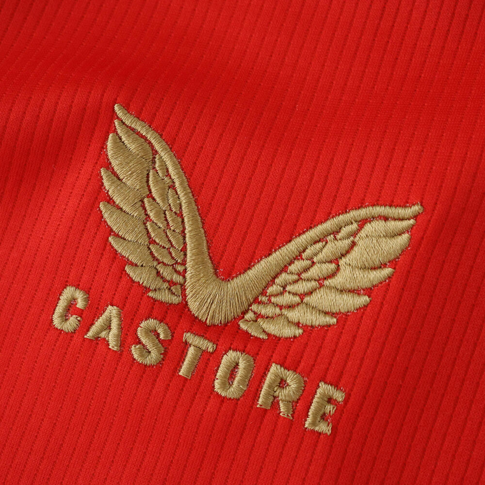 Gold Castore logo embroidered on the red Feyenoord Home 2025/26 Fan Version jersey fabric.