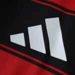 Close-up of the Adidas logo on the Flamengo 2025/26 Home Player Version jersey, showing red and black fabric.