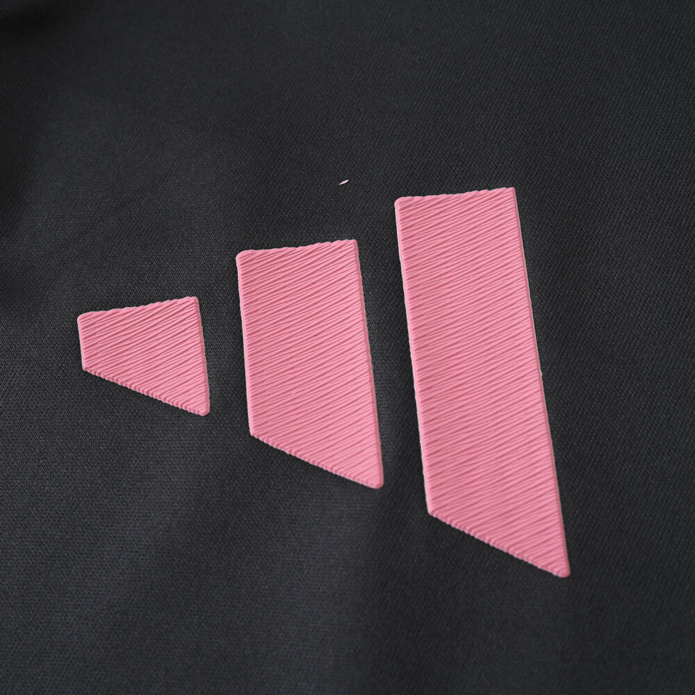 Close-up of pink adidas logo on the 2025/26 Inter Miami CF Away Player Version jersey fabric.