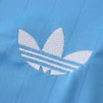 Close-up of the white Adidas Trefoil logo on the blue Inter Miami CF 2025/26 third fan jersey fabric.