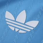 Close-up of the white Adidas Trefoil logo on the blue Inter Miami CF 2025/26 third player jersey fabric.