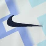 Close-up of the Nike logo on the Inter Milan Away 2025/26 Fan Version jersey with a geometric background.